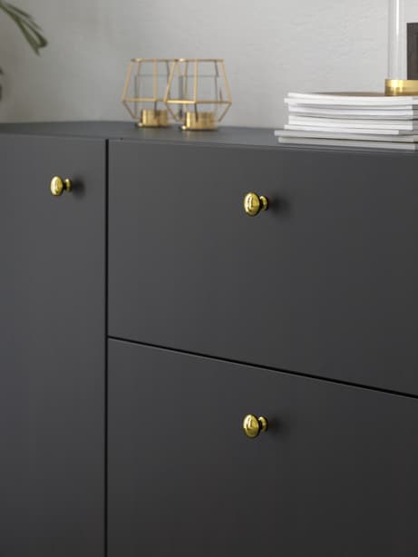 ENERYDA knob on black BESTA cabinet 