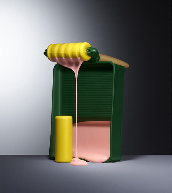 Ensemble de rouleaux à peinture colorés, avec peinture rose dégoulinante.