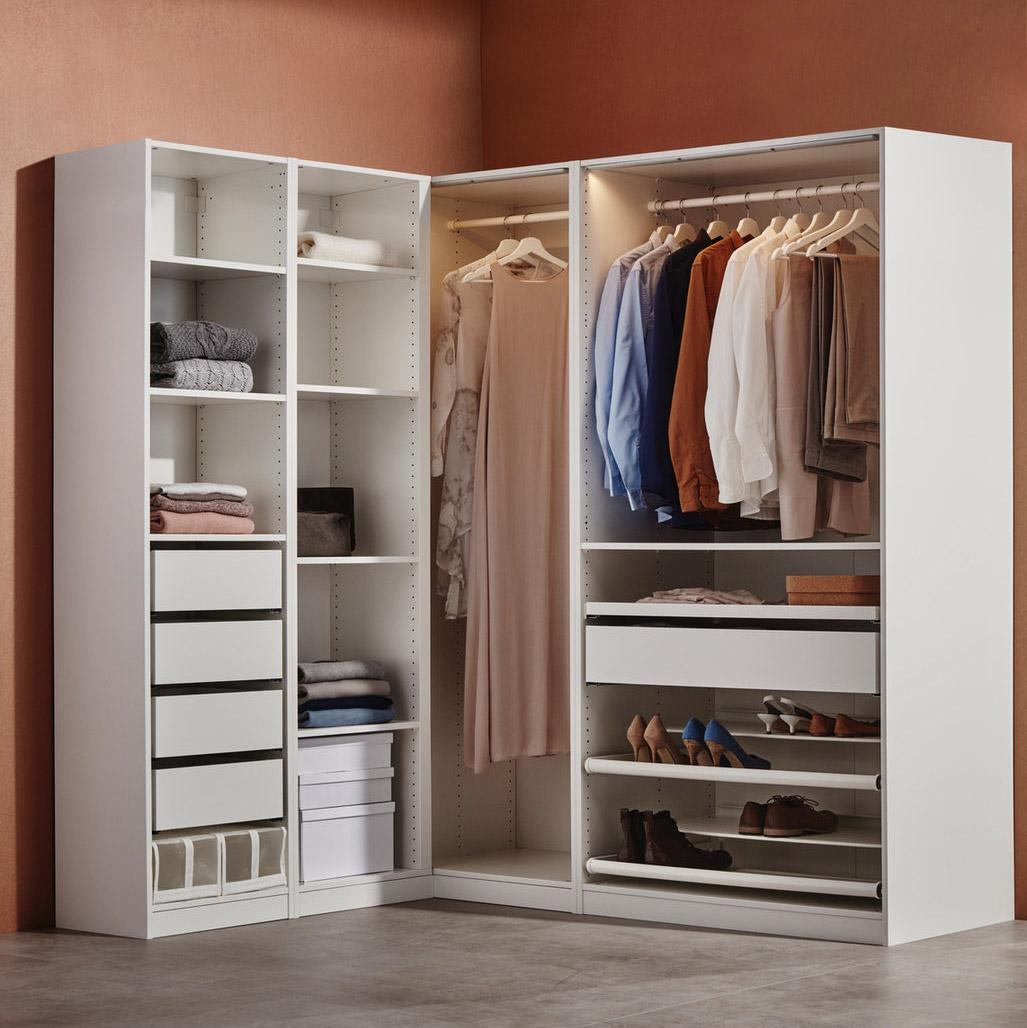 Et PAX hjørnegarderobeskab med skuffer, hylder, garderobestænger og skohylder.