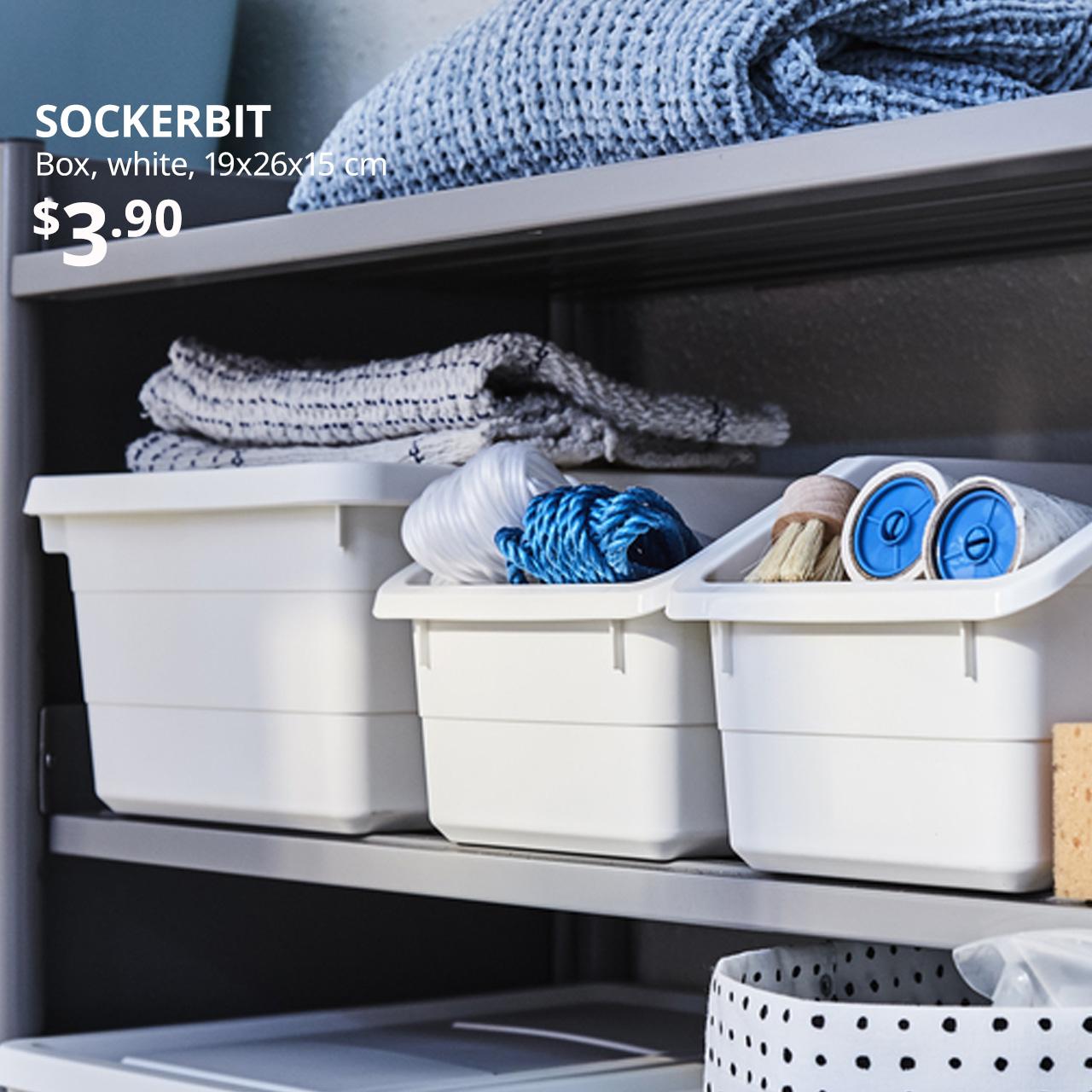 Everyday essentials. White SOCKERBIT boxes filled with BASTIS lint roller and household items placed on main entrance of the home.