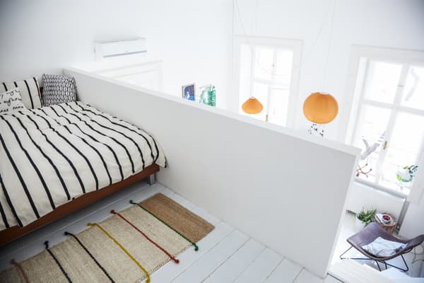 Extra cushions make a mezzanine bedroom feel cosy.