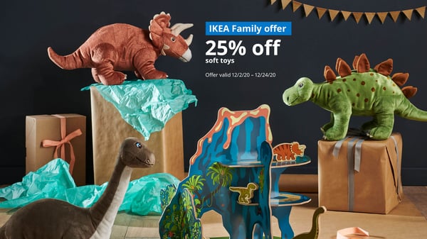 Several soft toy dinosaurs standing on top of gift boxes. IKEA Family offer 25% off soft toys, Offer valid 12/2/20 - 12/24/20