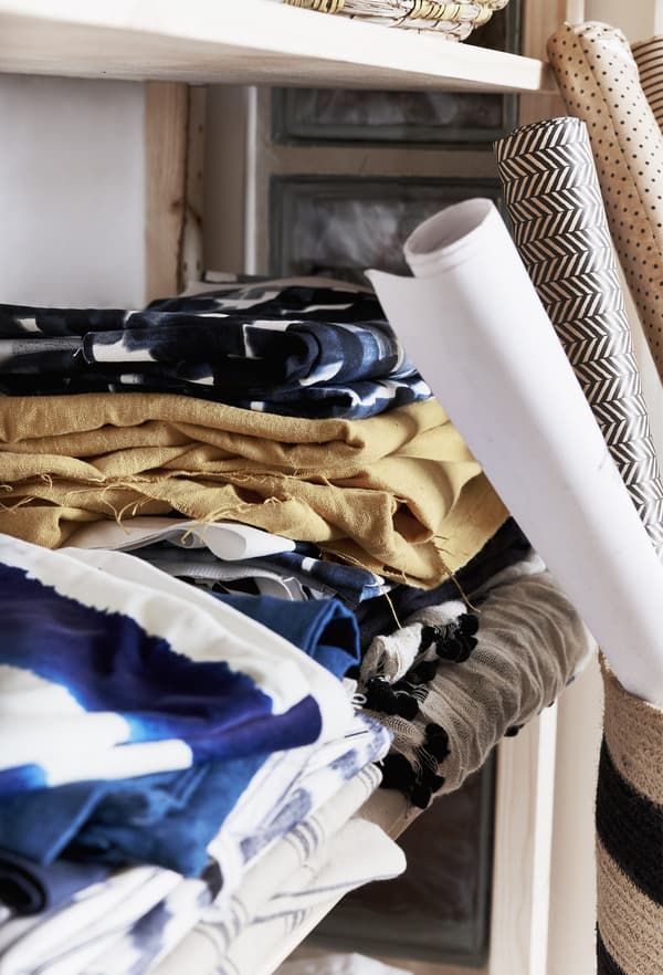 Fabric displayed on a shelf.