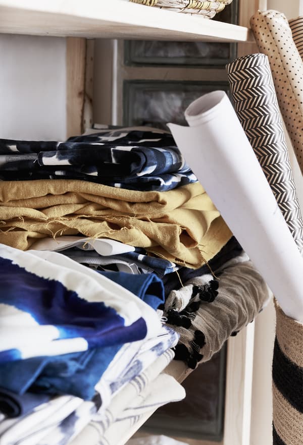 Fabric displayed on a shelf.