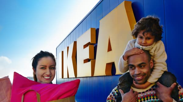 Family of (3) smiling after they leave the IKEA store with their purchased items