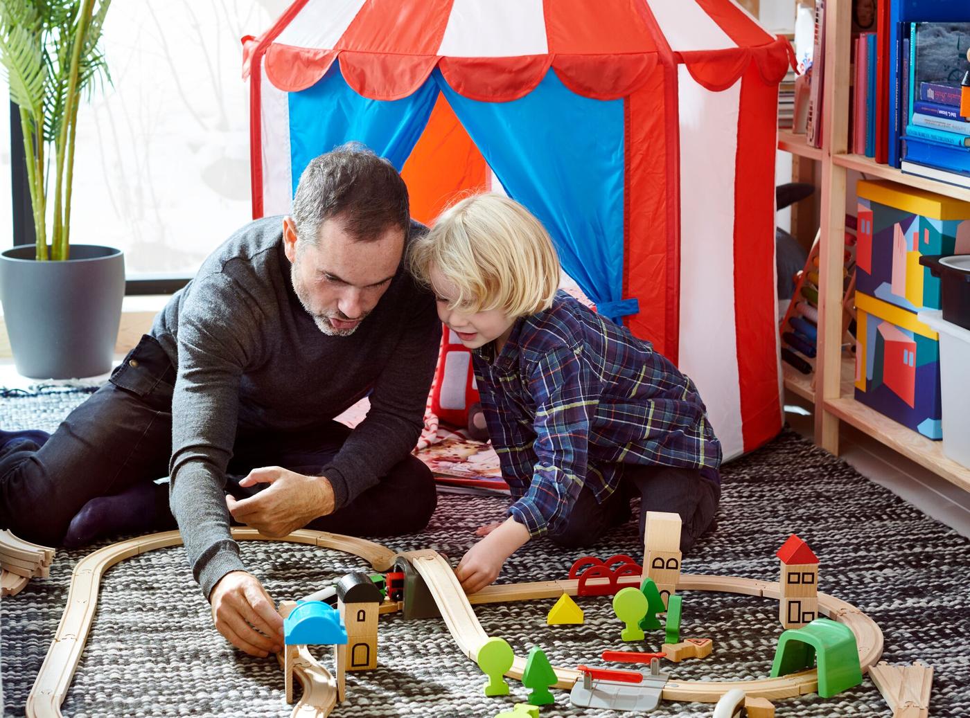 Farebný detský stan, v ktorom sa hrajú dve malé deti.