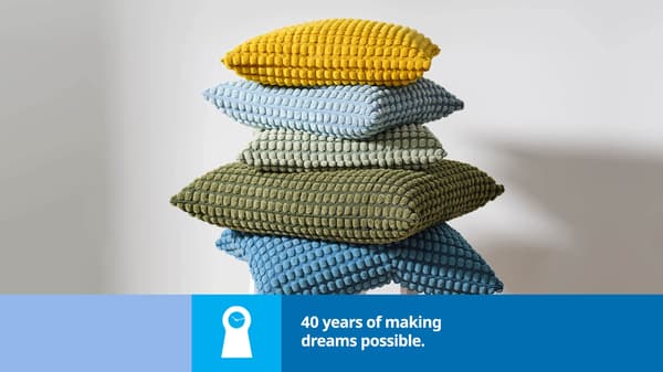 Five pillows in multiple colors stacked on top of each other