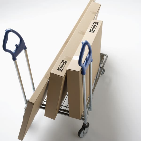 Flat-pack furniture boxes loaded on a rolling cart.