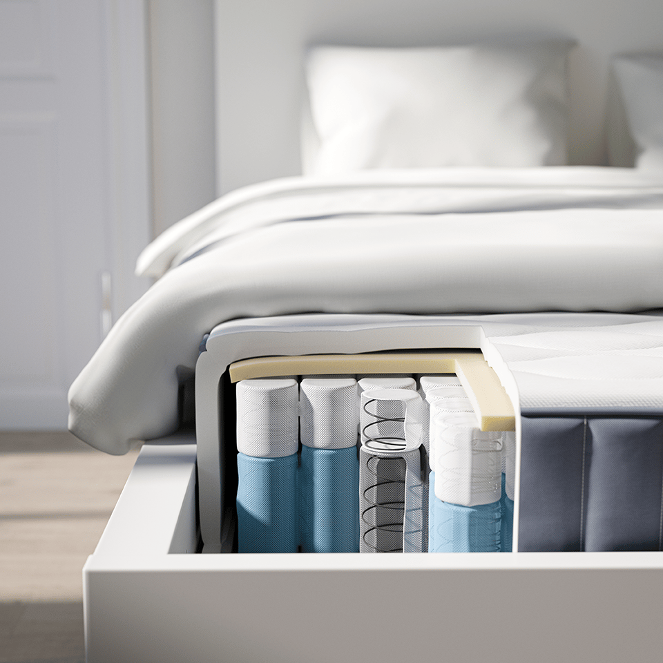 Fodenden af ​​en seng, med hjørnet af pocketmadrassen skåret ud for at vise lagene og fjederlommerne indeni.