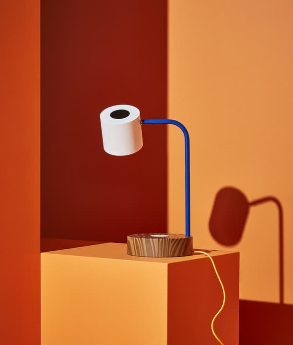 FÖRNYAD work lamp that looks like the big eye of the Darcel Disappoints character, shown against an orange background.
