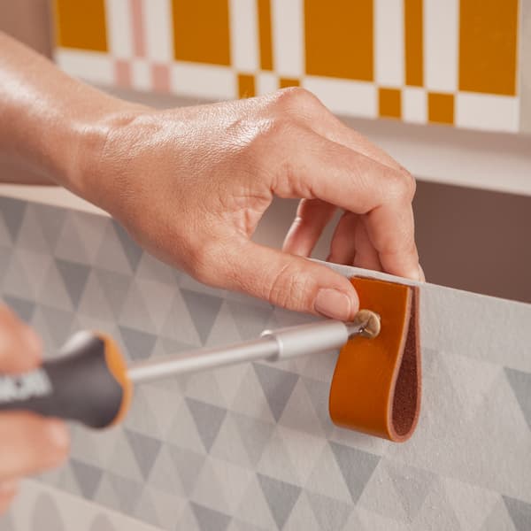 Fold the leather strips in half and secure them with a bolt and nut.