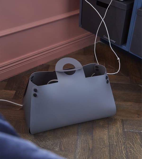 For a living room setup that’s inviting and accommodating for you and your friends, fix a dedicated place to charge phones.