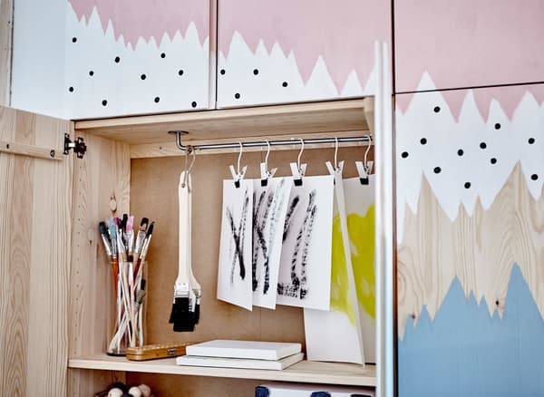Four IVAR cabinets painted with an abstract pattern and grouped together to show lots of storage.
