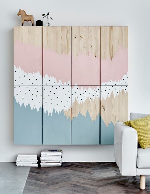 Four IVAR cabinets painted with an abstract pattern and grouped together to show lots of storage.