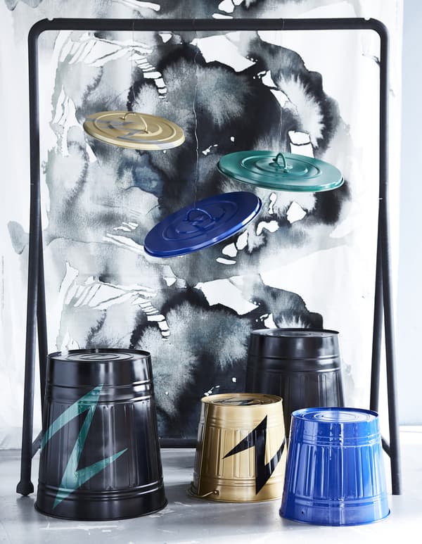 Four KNODD bins painted in different colours are turned upside down to create a drum set.