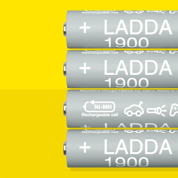 Four LADDA rechargeable batteries, HR6 AA with a battery capacity of 1900 mAh, lie beside each other on a yellow surface.