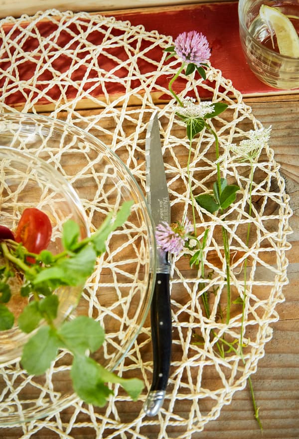Fresh flowers woven into a placemat.