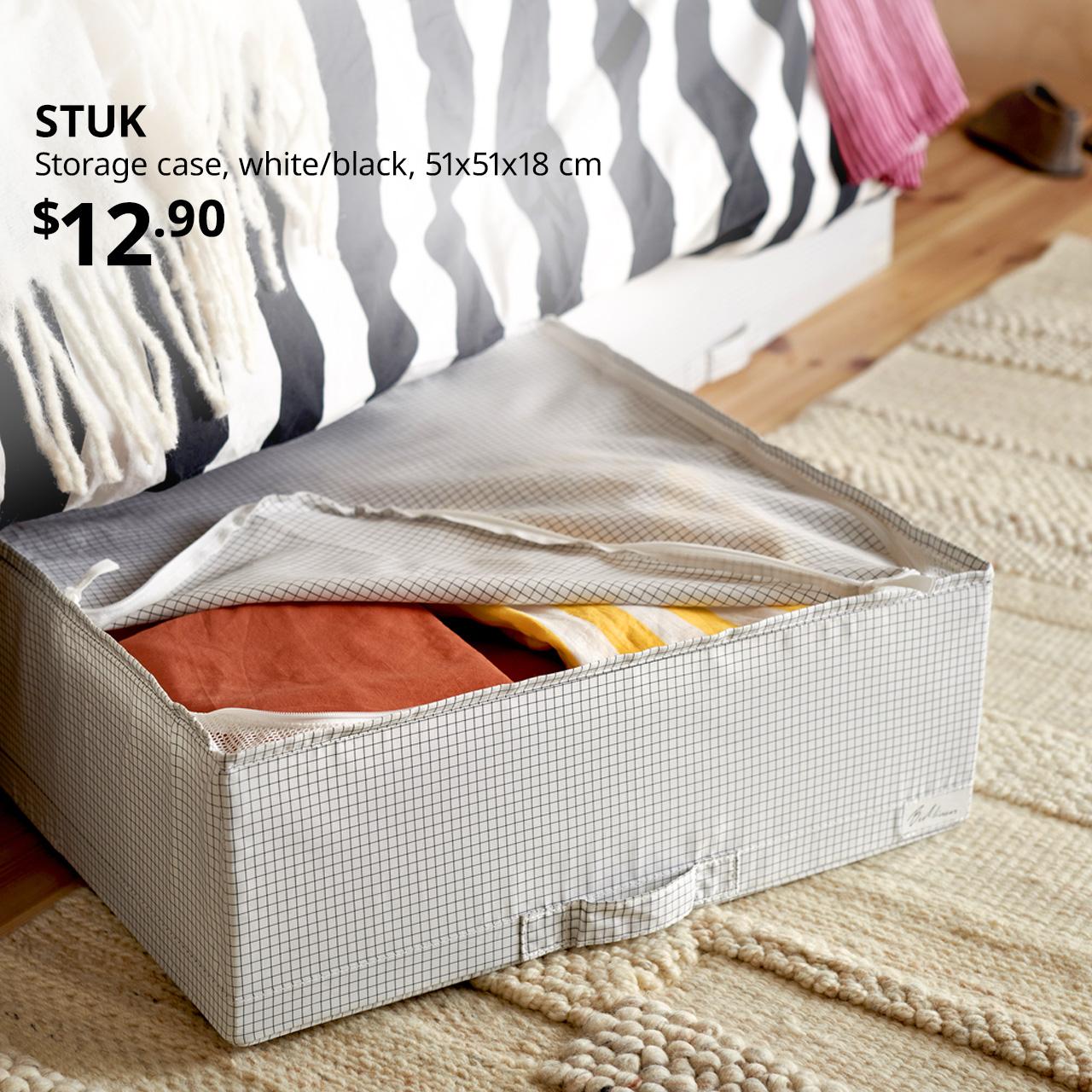Gap under bed frame reveals STUK storage case, white/black, 51x51x18 cm. Price: $12.90