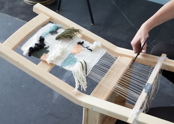 Get creative with a weaving project. When you’re happy with the length, cut the strings forming the framework and knot together to lock your weaving in place.