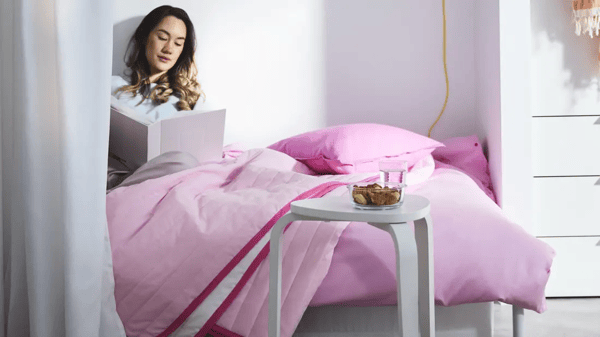 girl sitting on bed