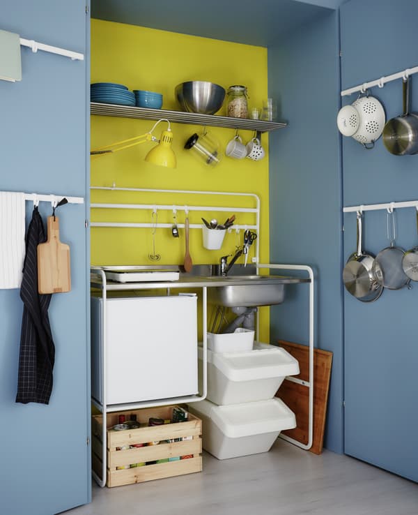 Give a tiny kitchenette all the benefits of a larger kitchen with lots of rails, shelves and boxes for storage.