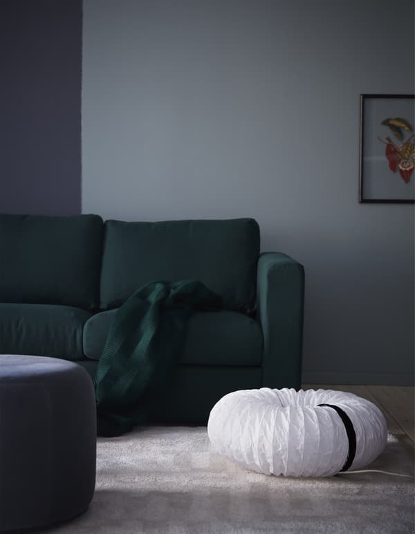 Give your room a unique glow with DIY light fixtures like this one made from an IKEA HOLMÖ floor lamp’s rice paper shade. The long, cylindrical shade gets shaped into a donut, so it looks almost sculptural on the floor next to a sofa. 