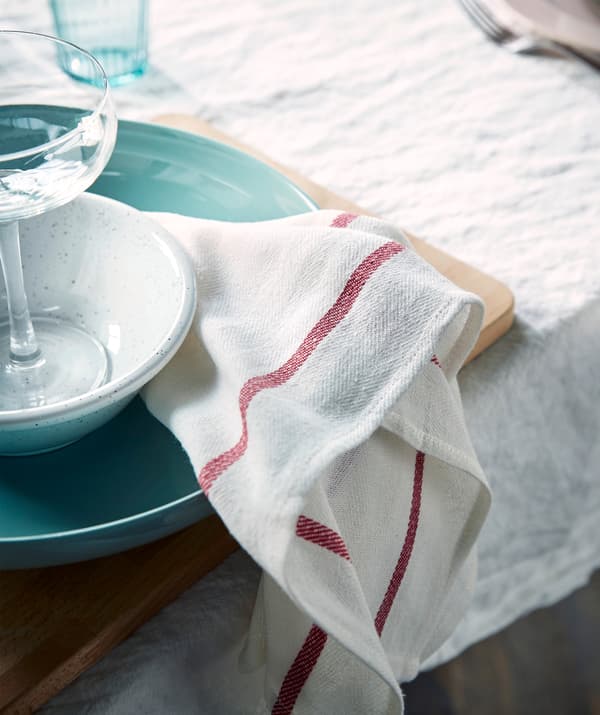 Give your table a cosy feel! Try tea towels instead of paper napkins, such as IKEA TEKLA white and red tea towel!