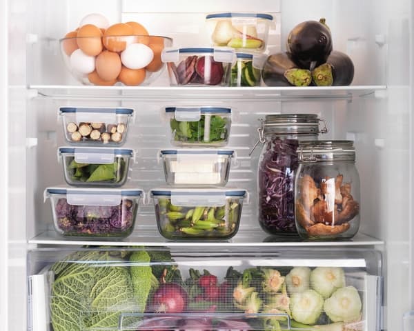 Glass jars and food containers used to organise a fridge