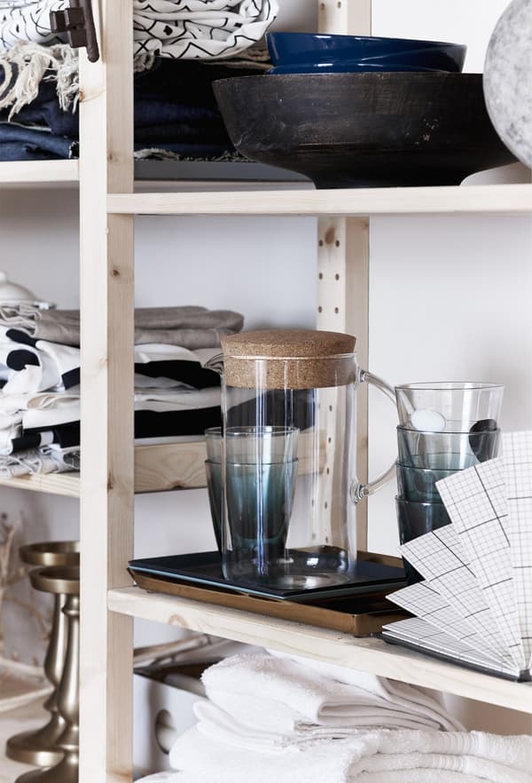 Glassware and ceramics on open shelves.