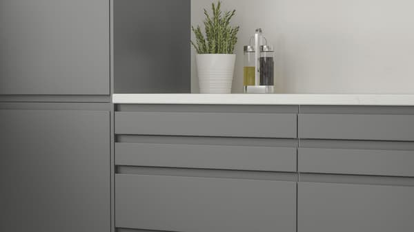 Gray kitchen cabinets with a white countertop
