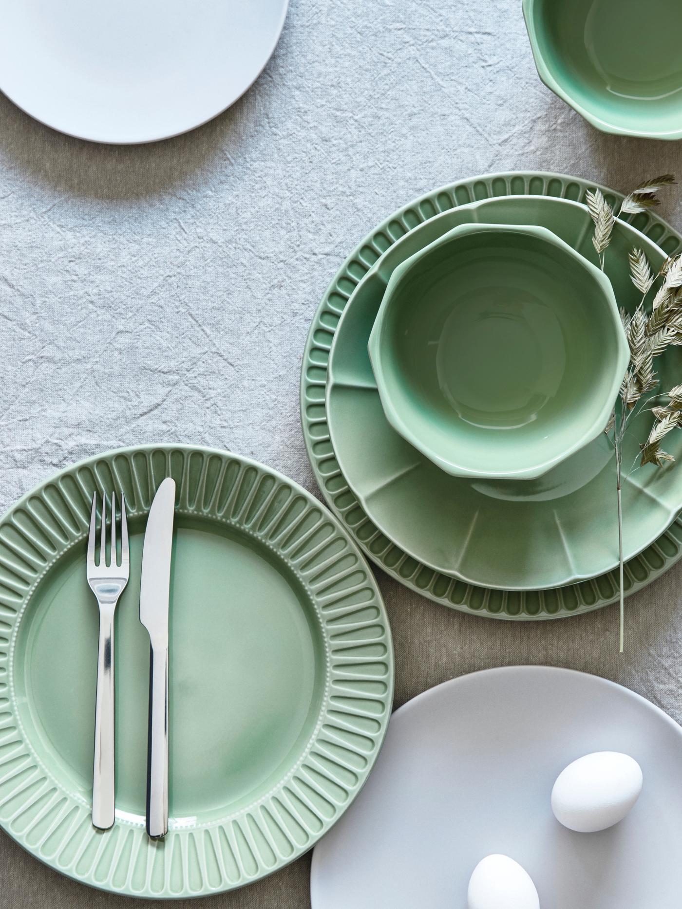 Green ceramic plate on dining table – Tableware