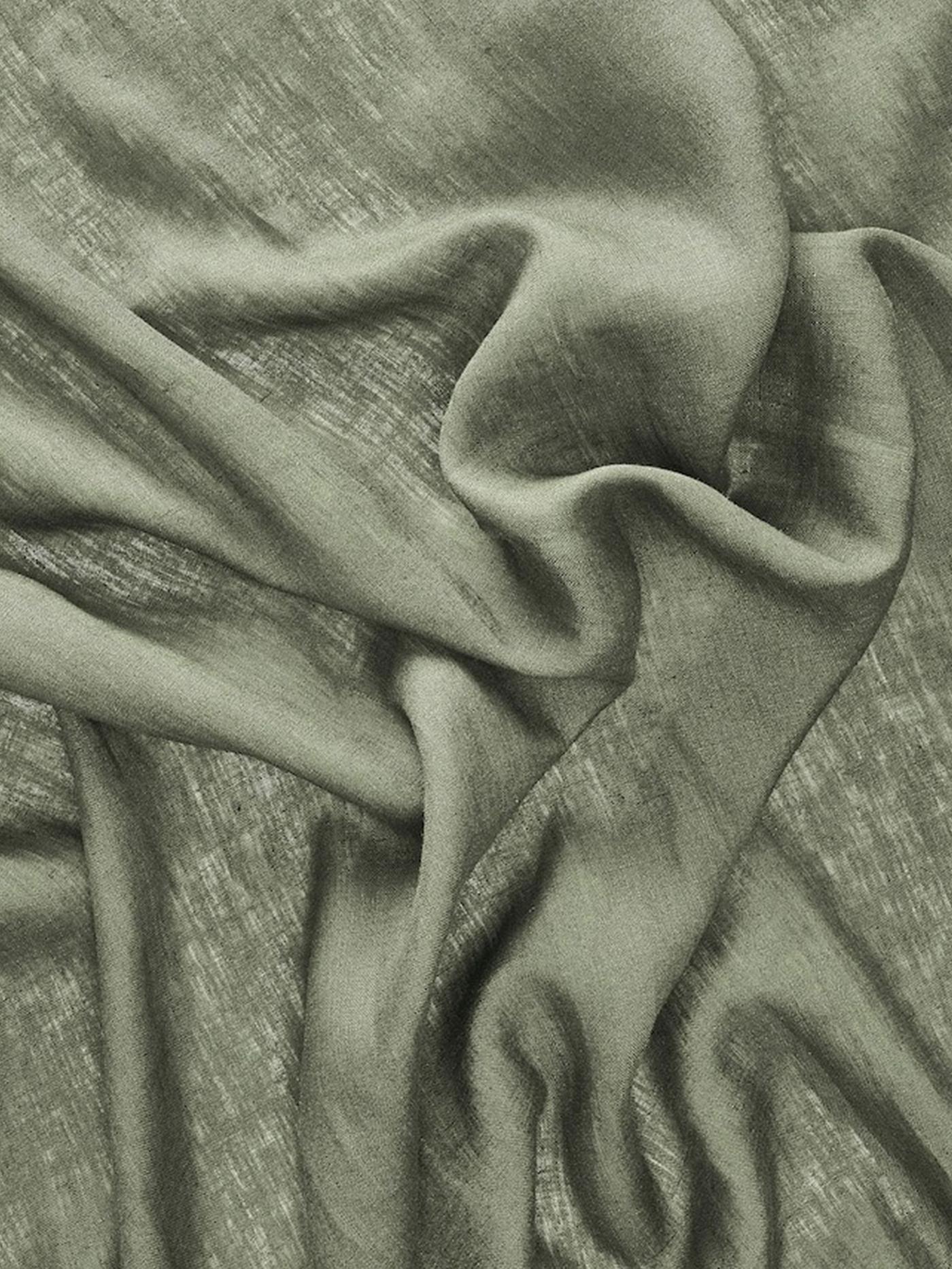 Green curtain fabric close-up.
