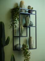 Green decorations and FEJKA on a black display bookcase.