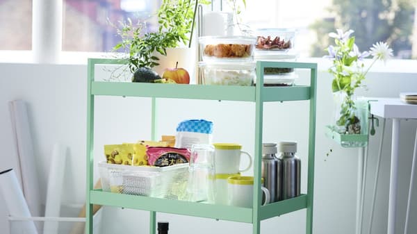 Green rolling cart filled with ikea storage products 