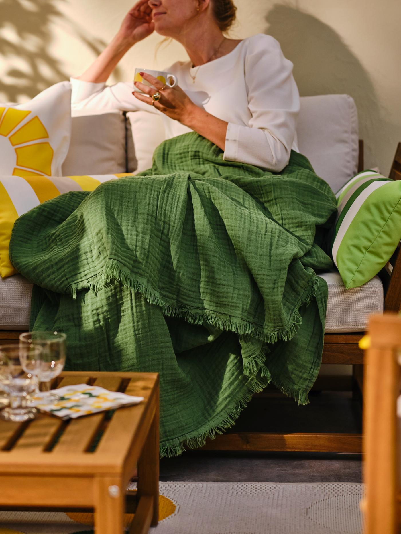 Green throw used on ourdoor furniture