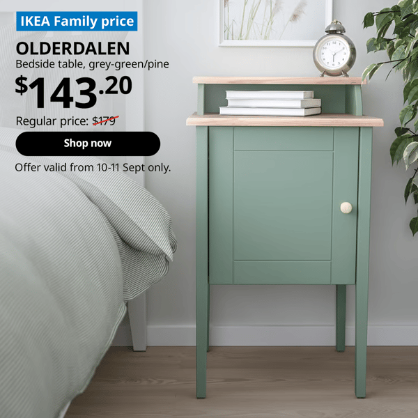 Grey-green OLDERDALEN bedside table in a simple bedroom with books and an alarm clock on top.  Words on image read "IKEA Family Price, RACKNAS, chest of 3 drawers, wall-mounted, $79.20, Regular price, $99 with a slash, shop now, Offer valid from 10-11 Sept only"