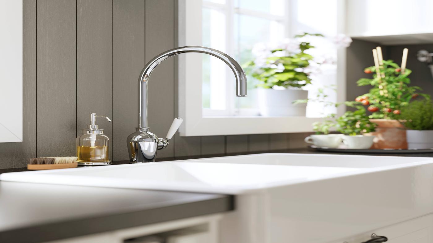 Grifo sobre lavaplatos blanca.