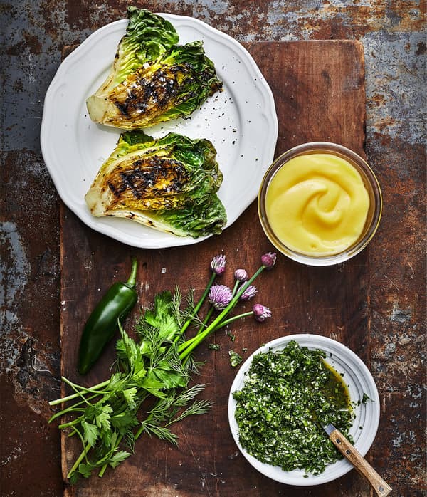 Grilled lettuce and herbs, accompanied by an golden yellow dip sauce and gremolata made with IKEA SMAKRIK rapeseed oil.