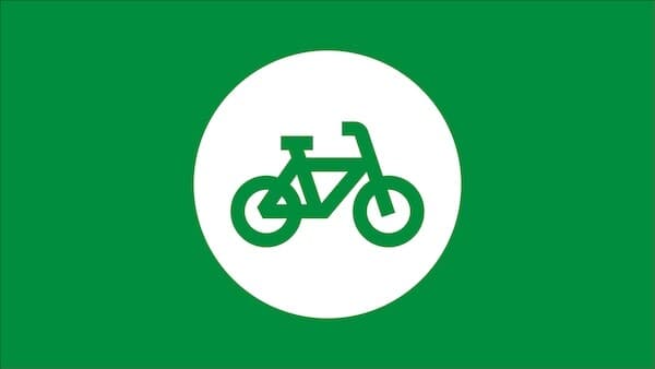 Groen pictogram van een fiets op een groene achtergrond met een witte cirkel.