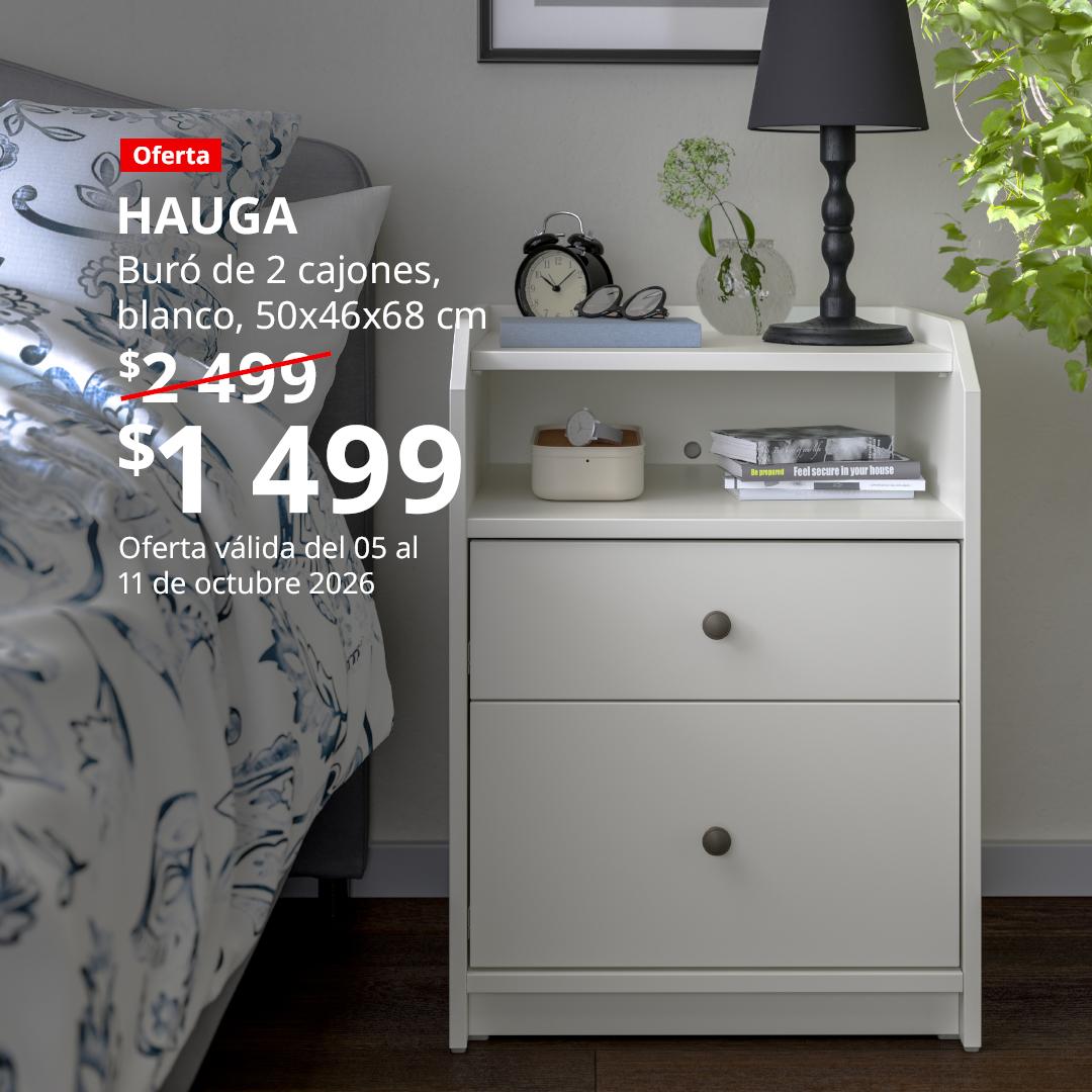 Habitación con un HUAGA buró, a un lado de una cama.
