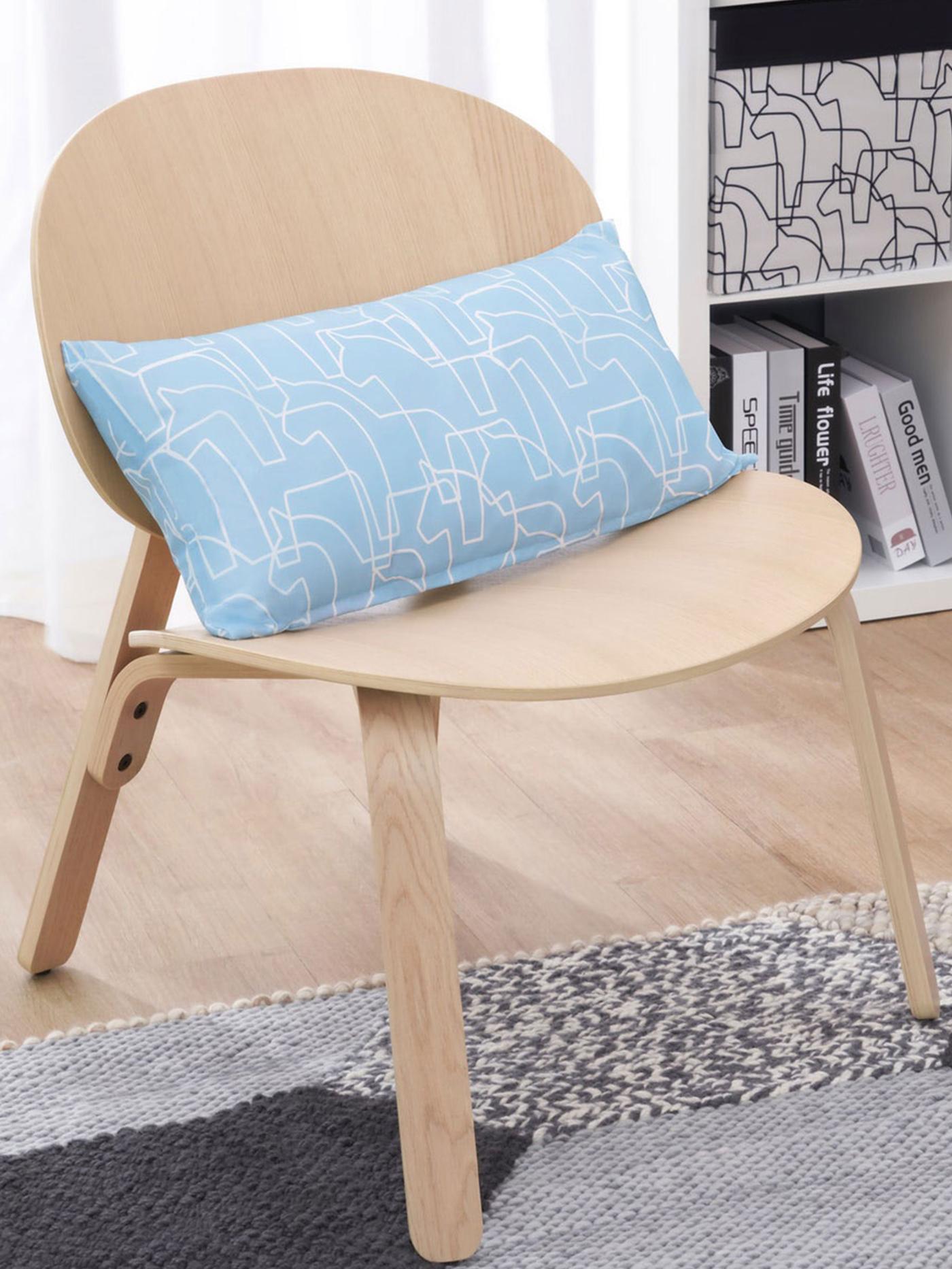 HÄSTHAGE cushion on a chair.