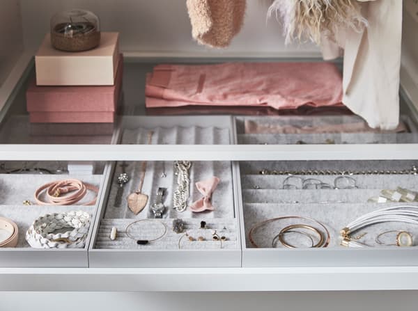 Halssnoeren, armbanden en andere sieraden in vilten IKEA KOMPLEMENT dozen.