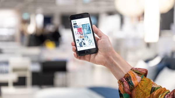 Hand holding smart phone with IKEA app on screen
