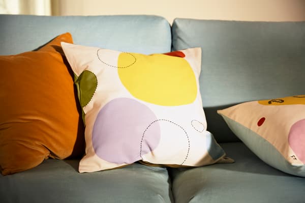 Handmade cushions on top on a grey/green couch