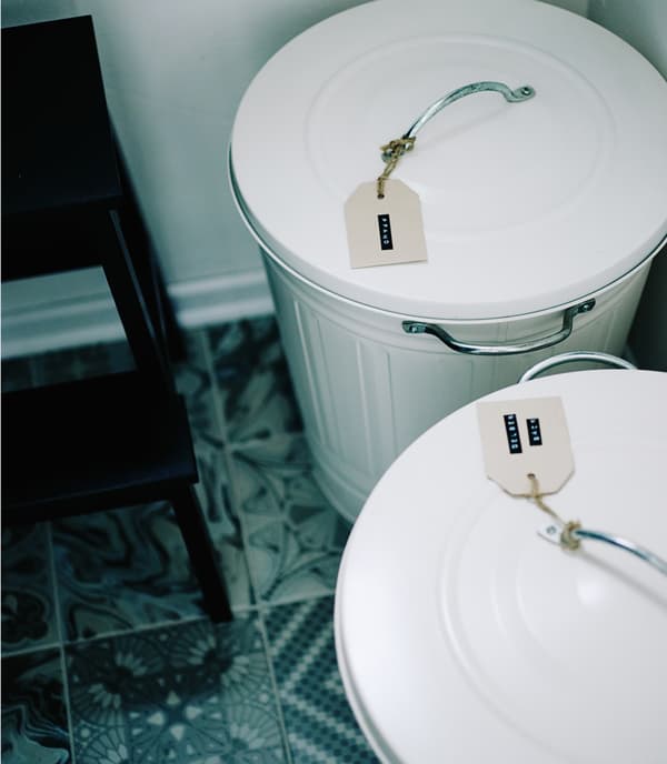 Handmade tags on white recycle bins.