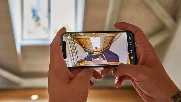 Hands hold a phone. You will see the KREATIV app on your phone 