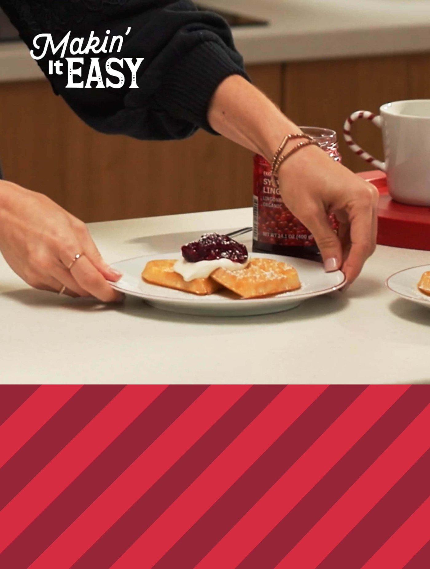 Hands placing a plate of waffles with cream and berry topping; text reads “Makin’ It EASY."