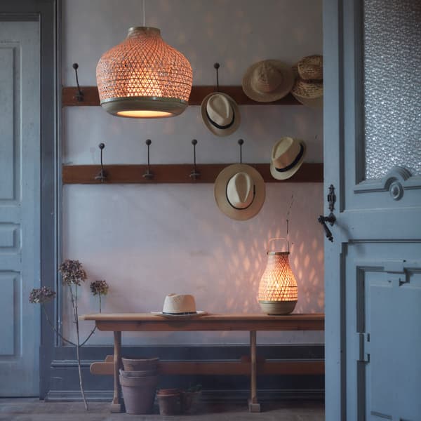 Handwoven in bamboo, MISTERHULT pendant lamp and table lamp are used to create cosy mood light in a hallway space.