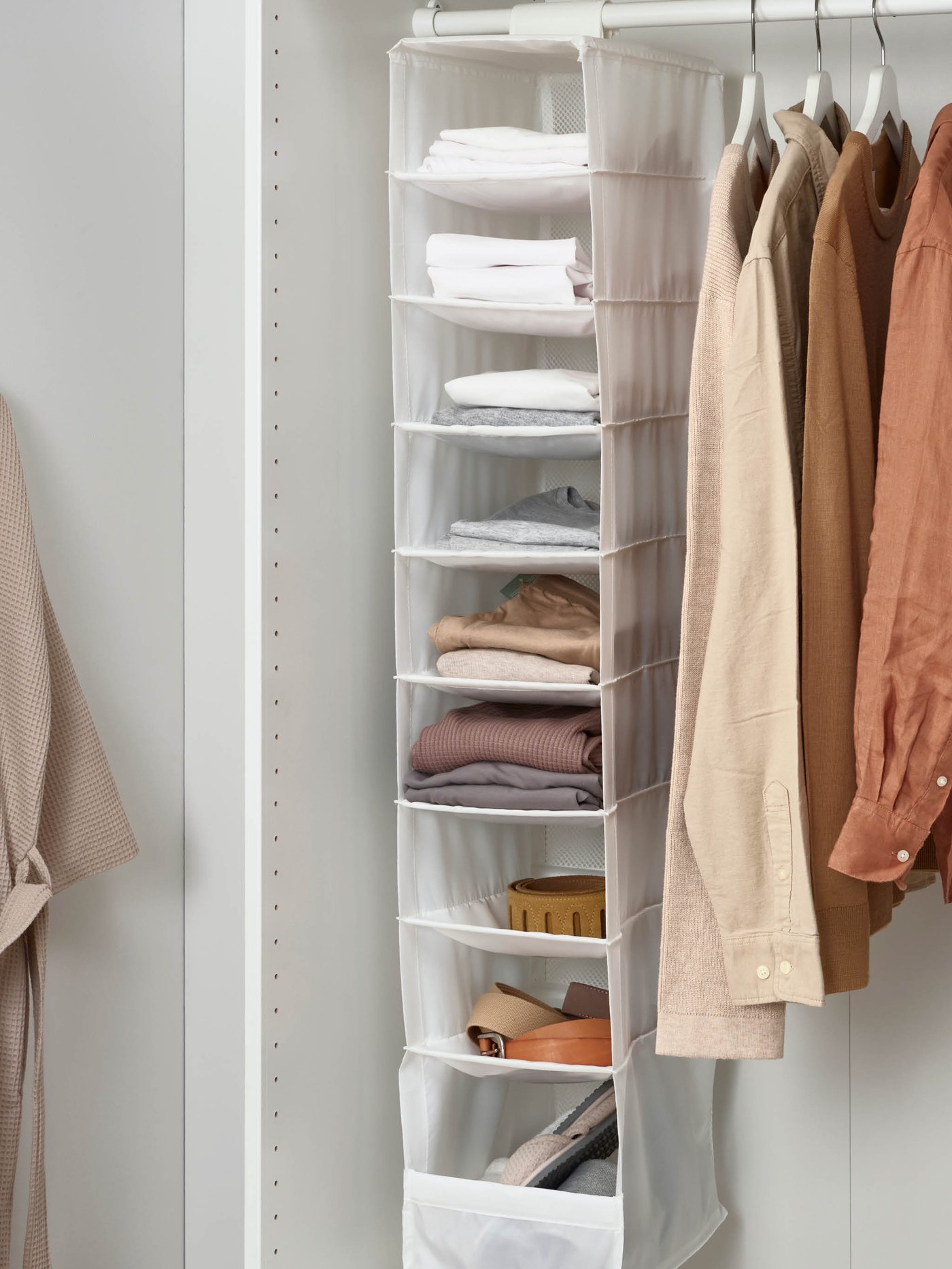 Hanging clothes organiser in wardrobe