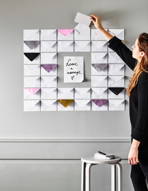 Hanging envelopes and coloured paper on the wall makes for a sweet wall decoration and message board.